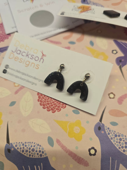 Black glitter arch earrings