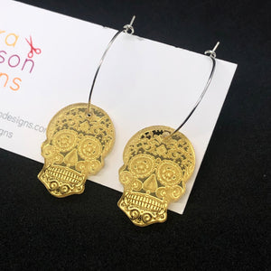 Skull hoop earrings (available in gold, silver, and pink)